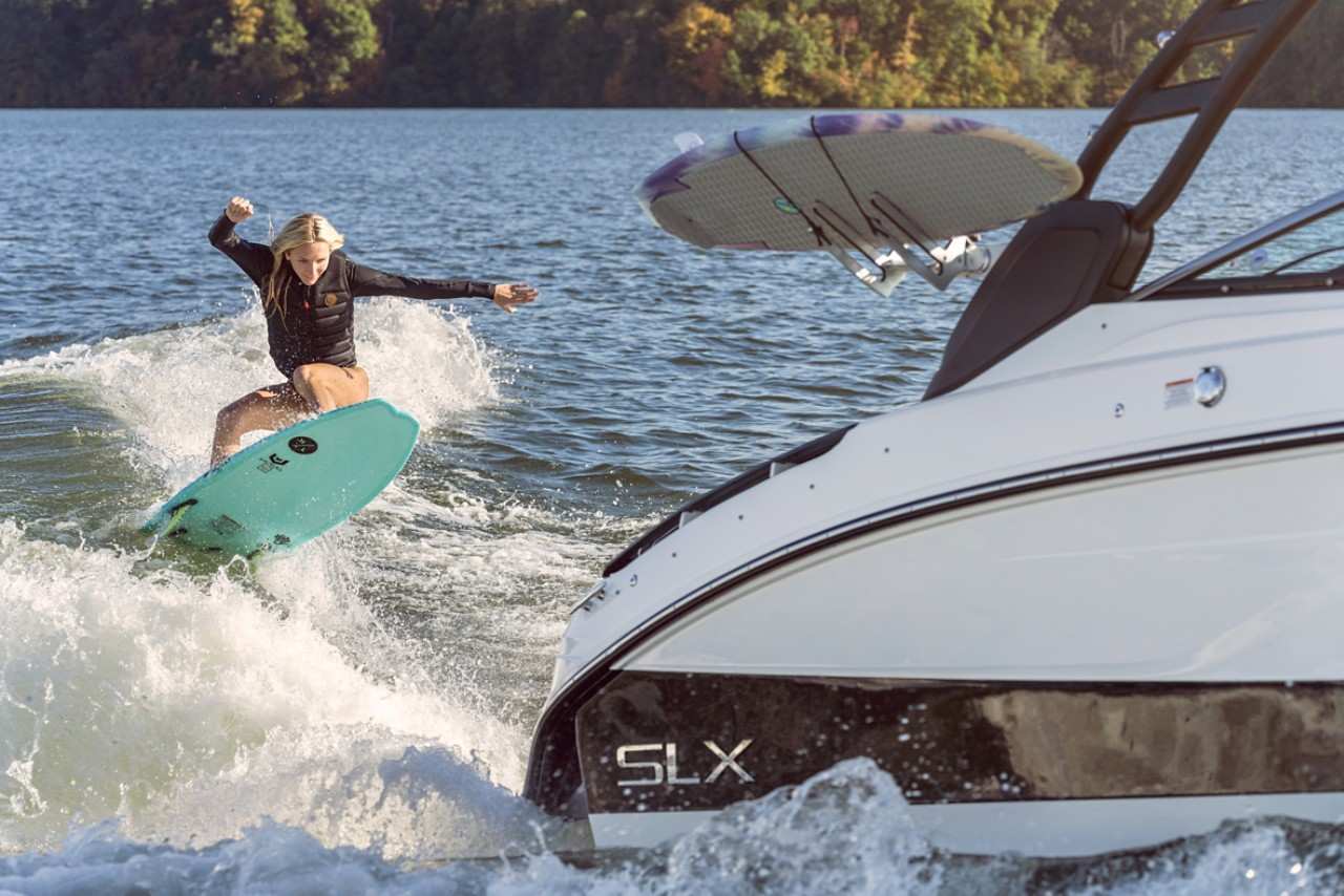 2024 SLX 260 Surf with young woman wakesurfing