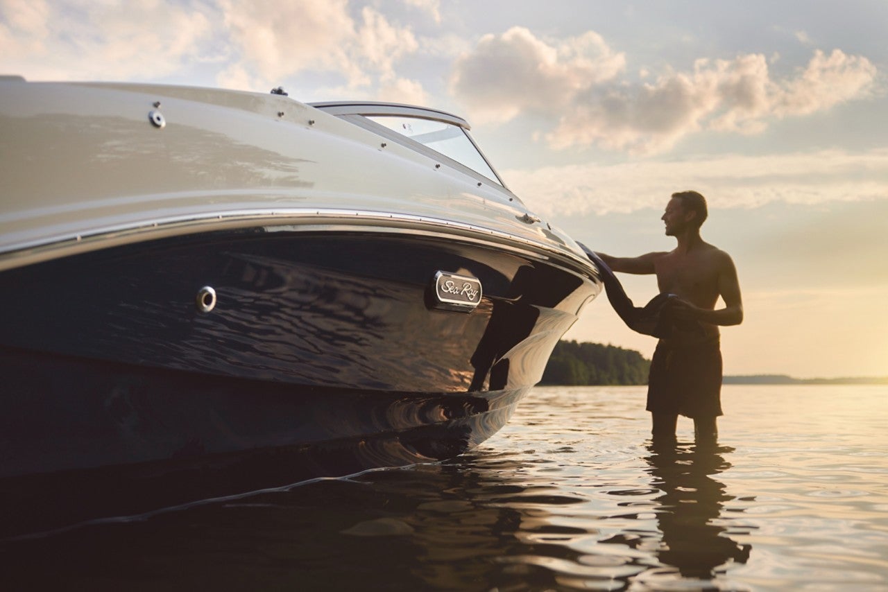 Man next to an SPX 190 Outboard at sunset