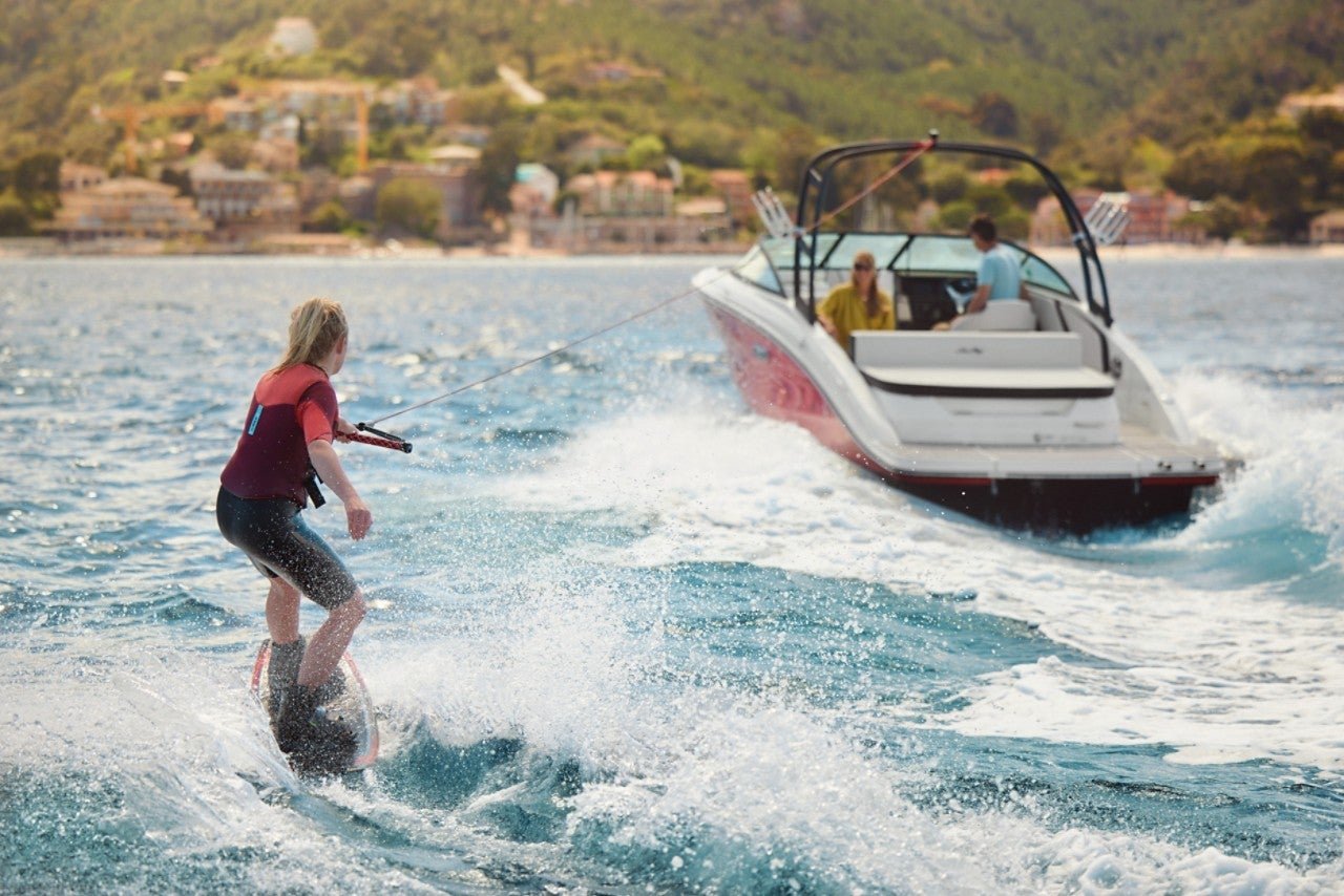 Woman wakeboarding behind an SPX 210