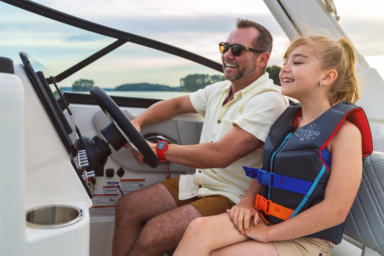 Father and daughter at the helm of an SDX 250 Outboard