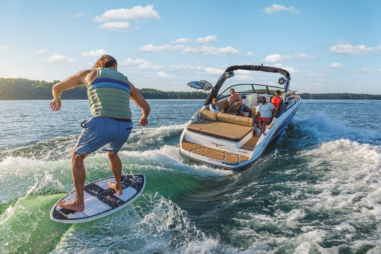 Man wakesurfing behind an SDX 250 Surf