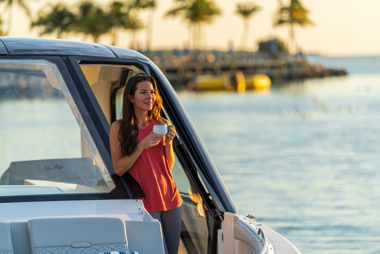 Woman on bow of 2024 Sundancer 370 Outboard