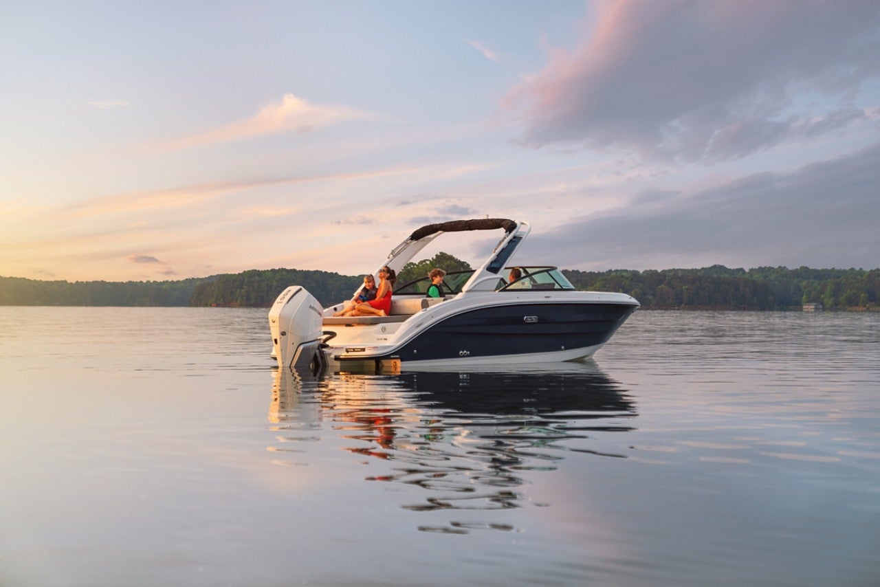 Family aboard an SDX 250 Outboard at sunset