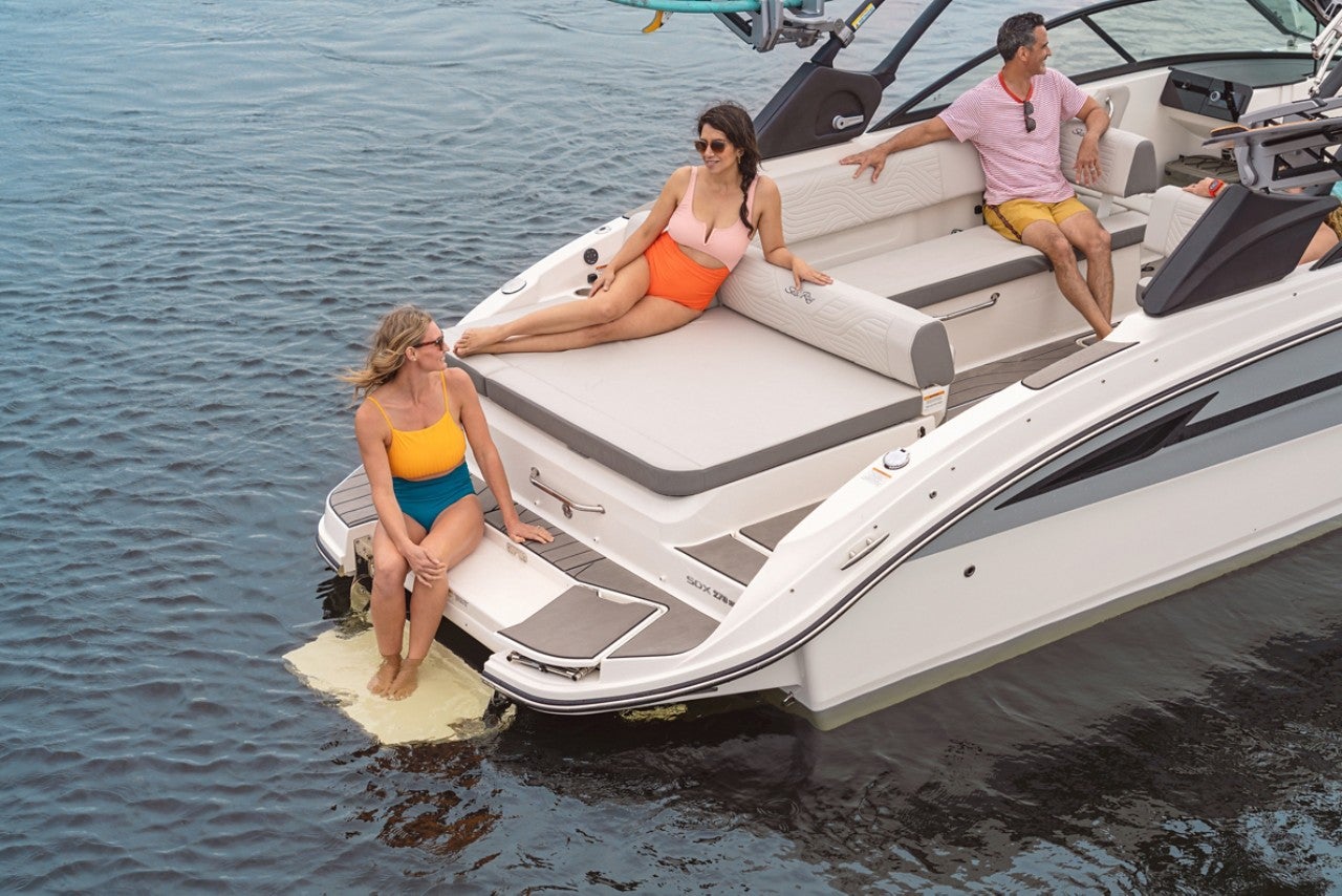 Friends aboard an SDX 270 Surf