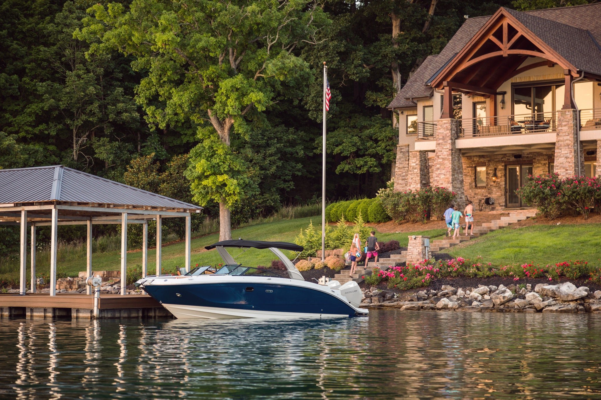 SDX 290 Outboard at a dock in front of a house