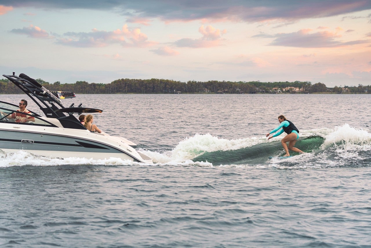 Woman wakesurfing behind an SDX 270 Surf