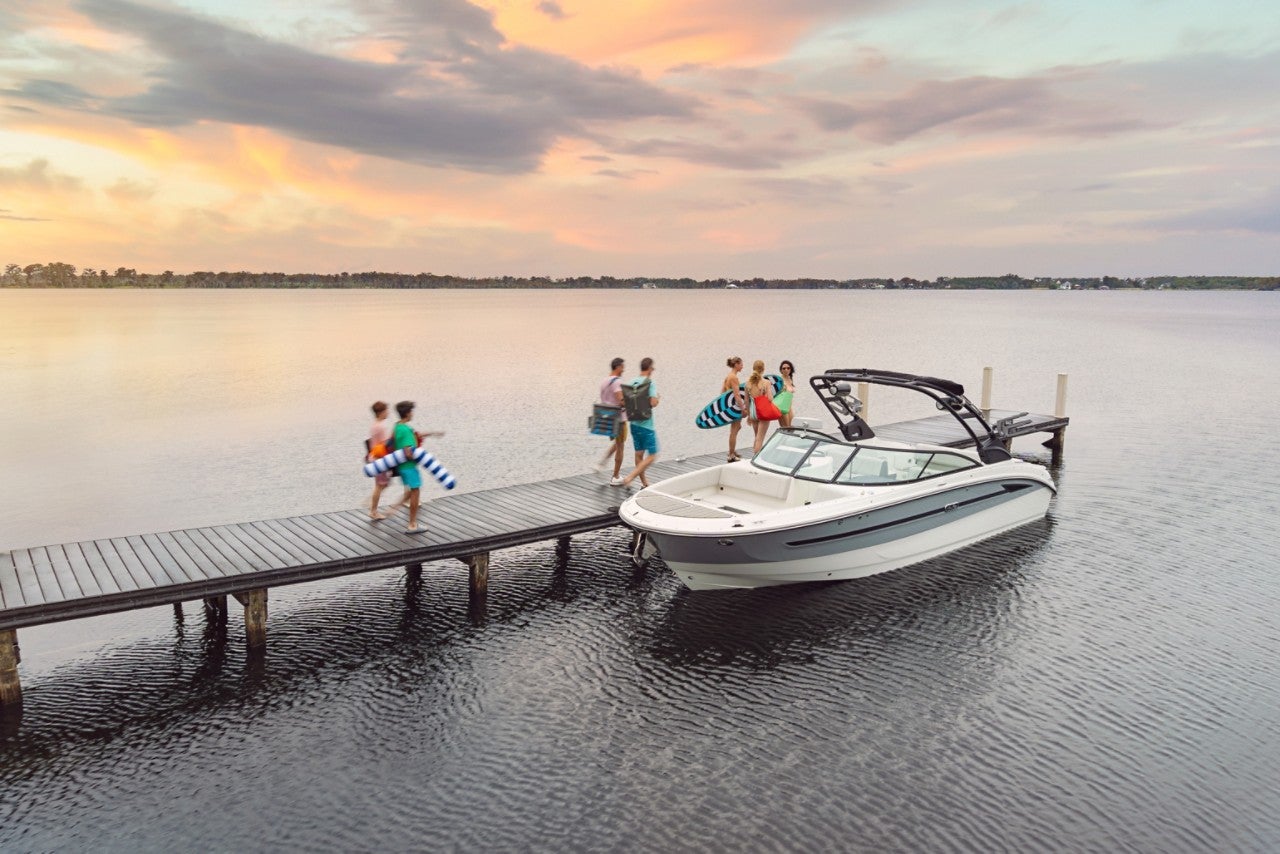 People walking on a dock toward an SDX 270 Surf