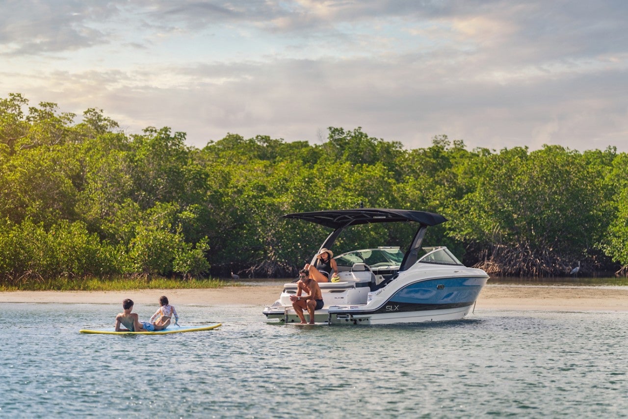 Family enjoying a day on the water with an SLX 260