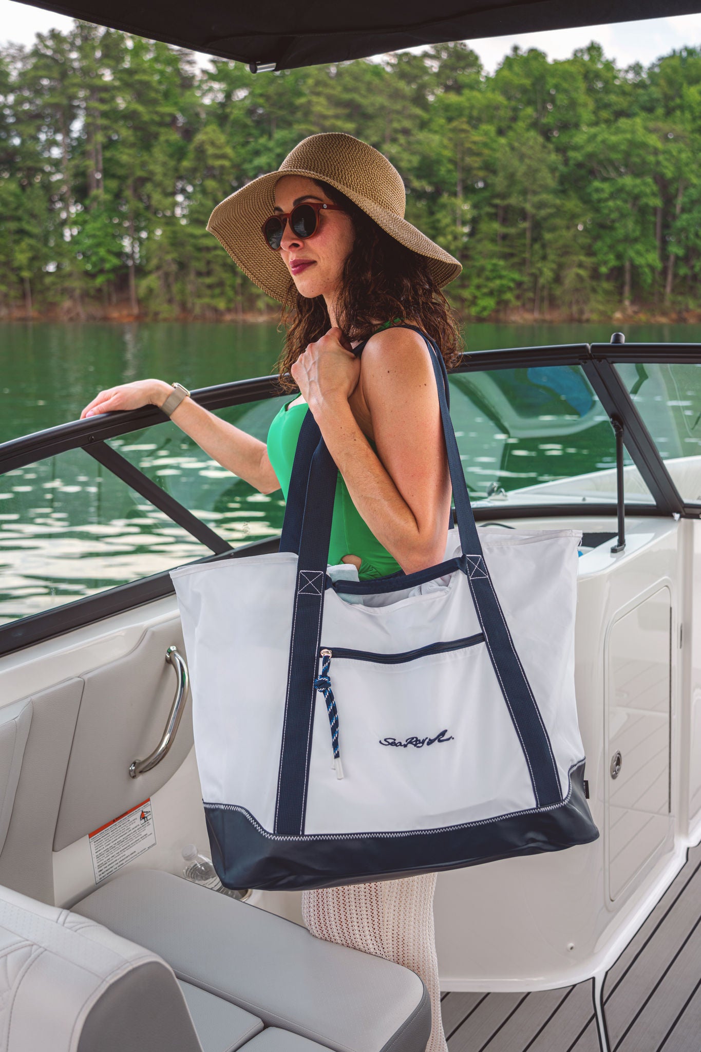 woman holding a white Sea Ray boat bag