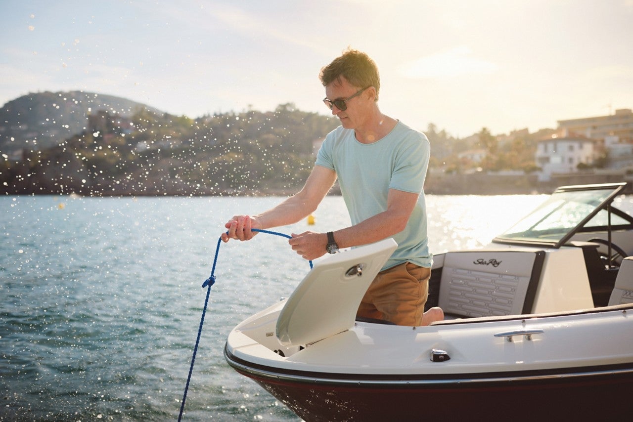 Man lowering the anchor from an SPX 210 Outboard