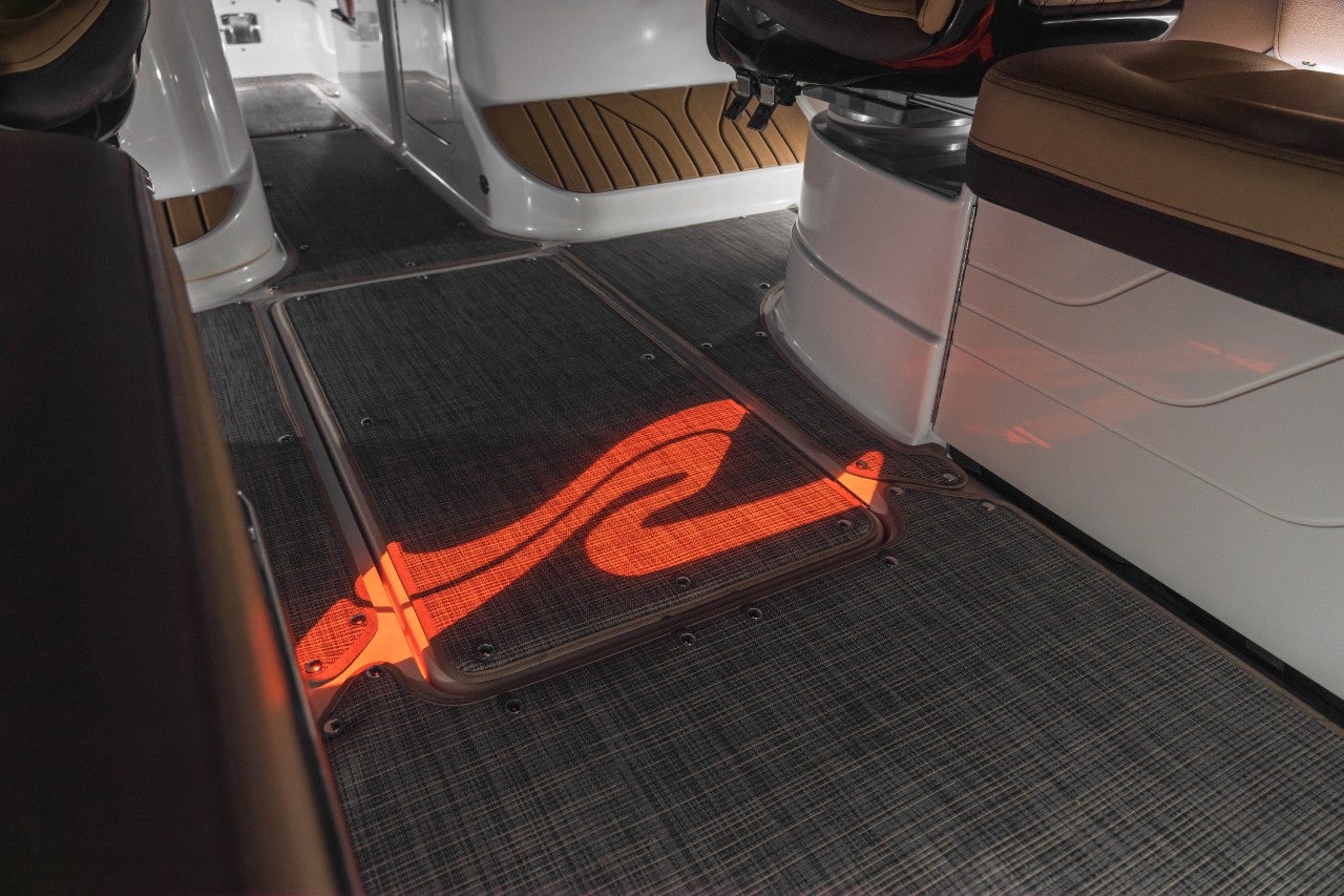 Sea Ray logo light projected onto the cockpit floor of an SLX 260 Surf