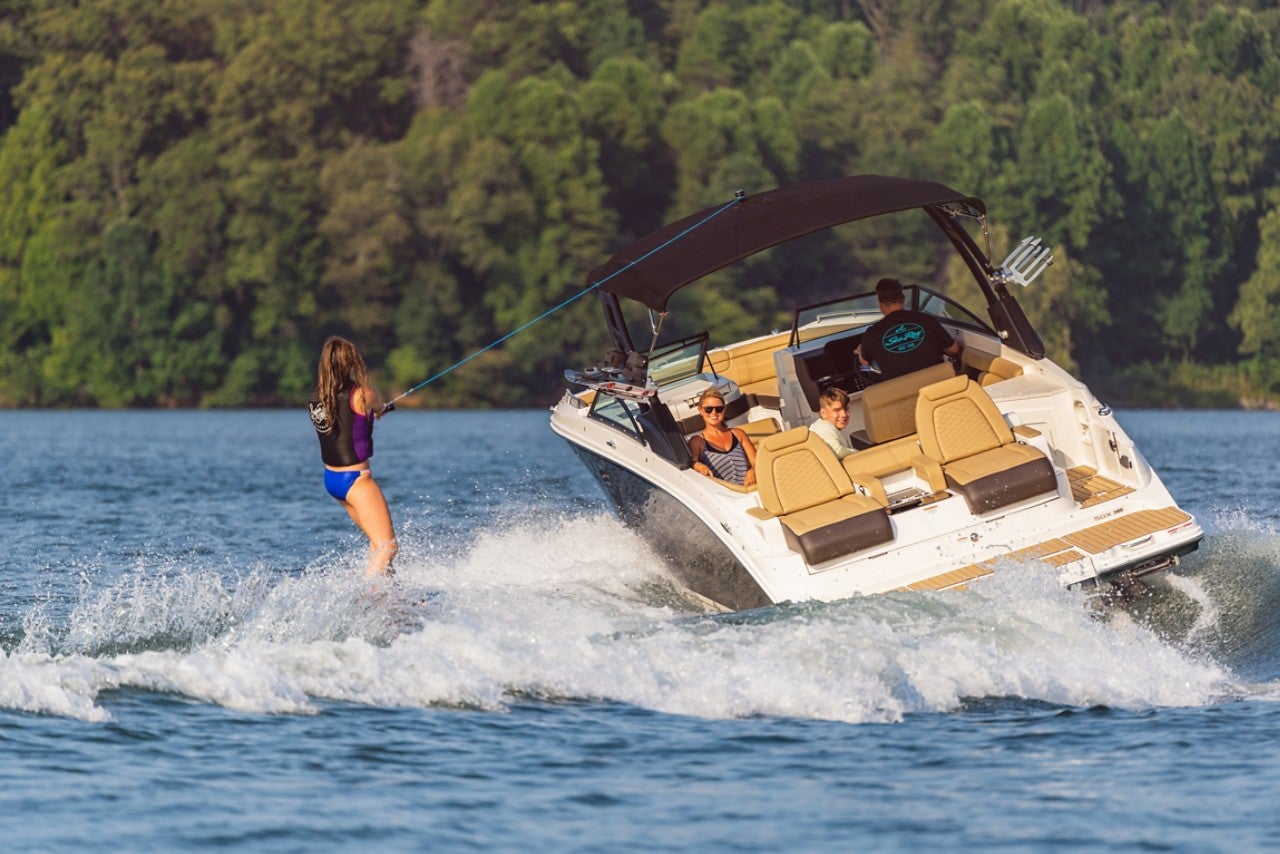 Teen girl wakeboarding behind an SDX 290