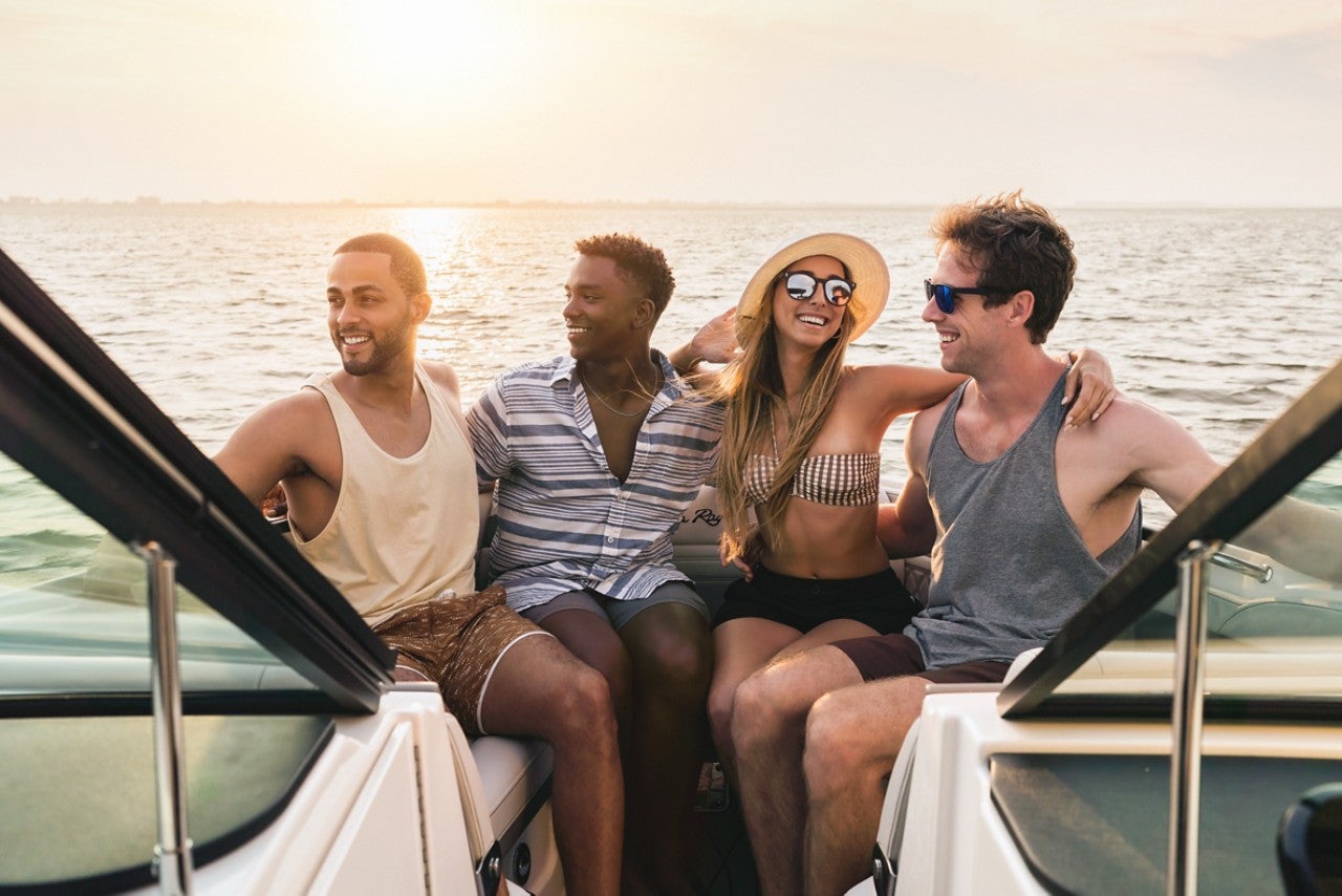 Friends aboard an SLX 280 at sunset