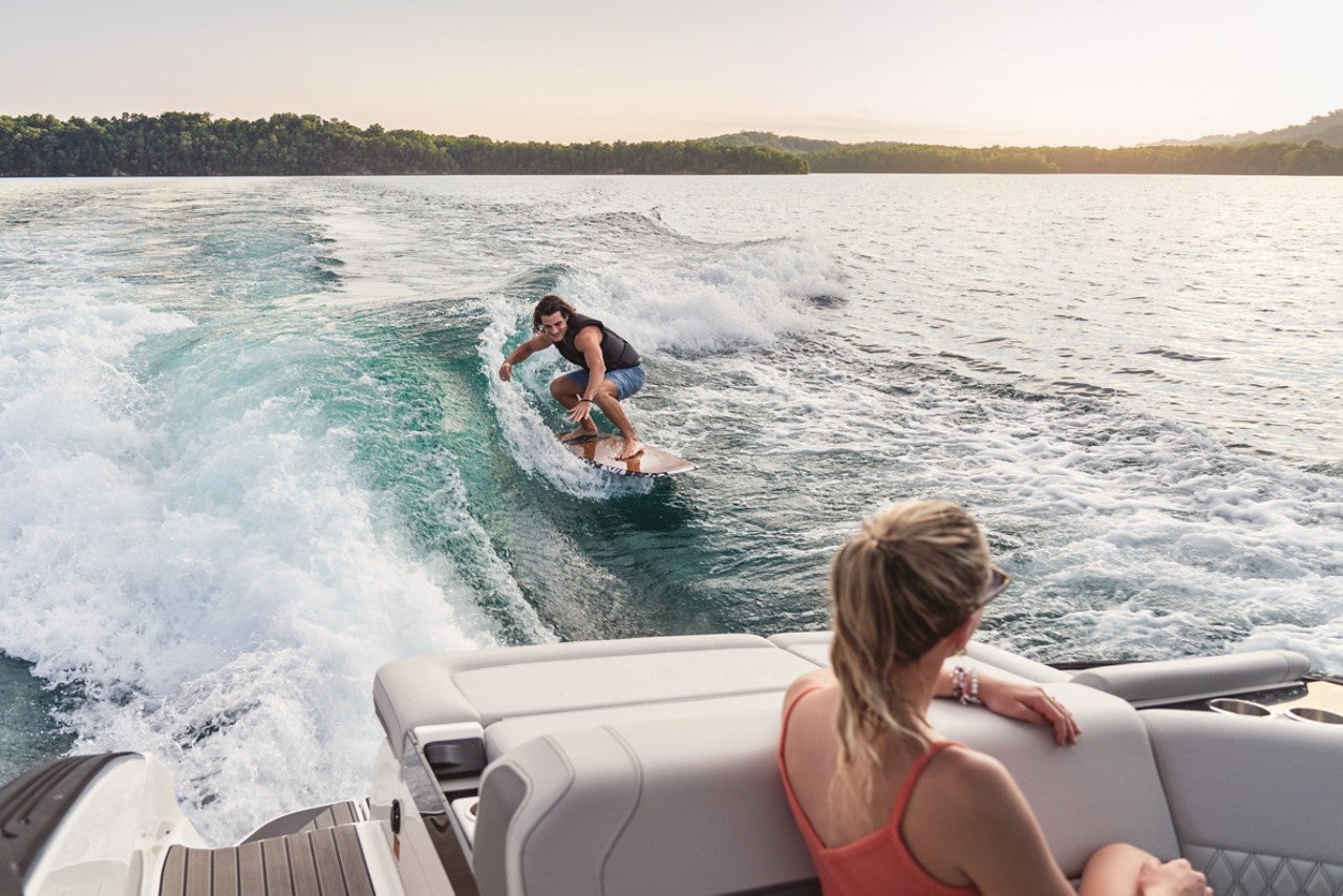 Man wakesurfing behind an SLX 260 Surf