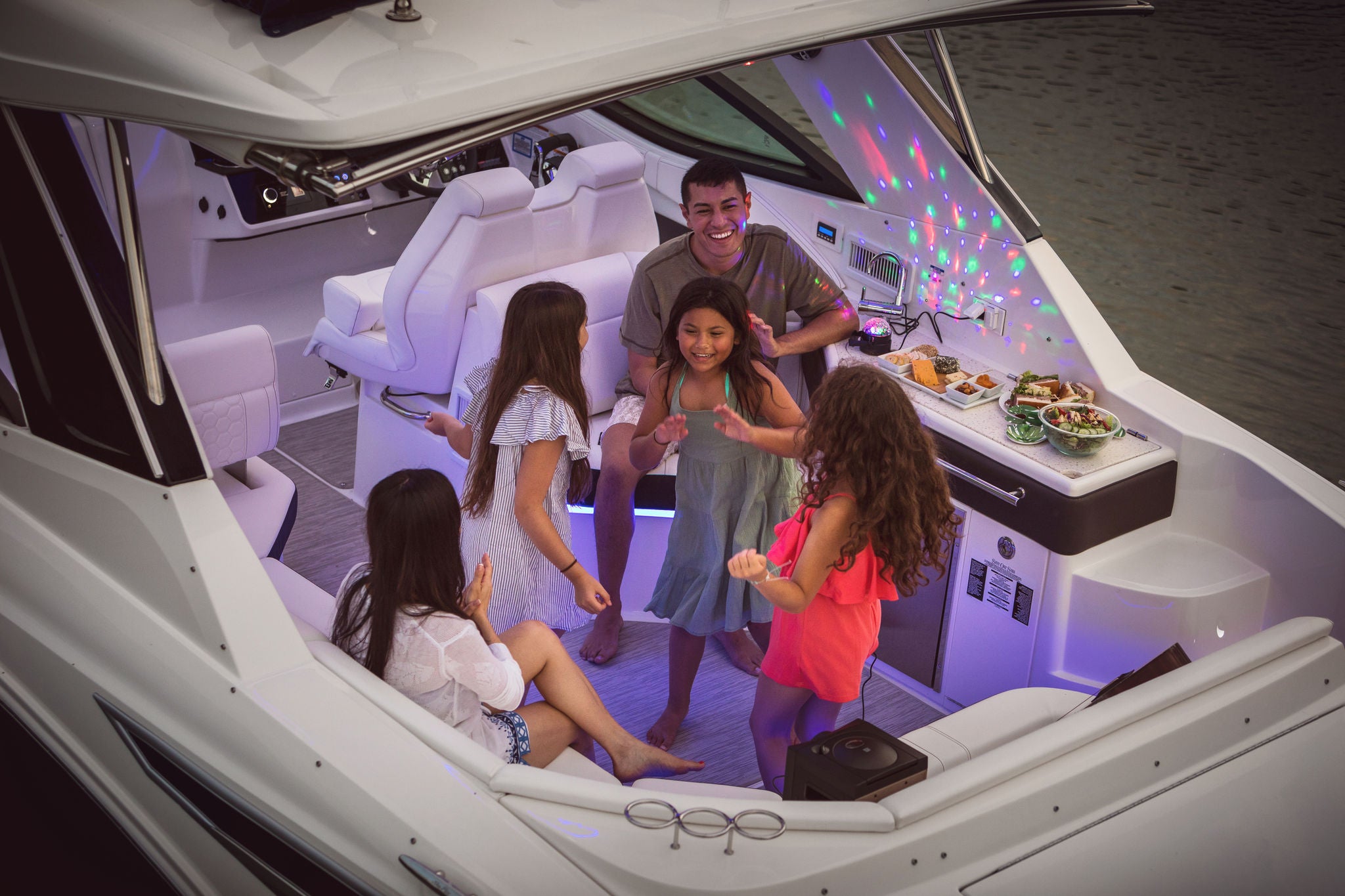 Family enjoying a fun evening aboard a Sundancer 320