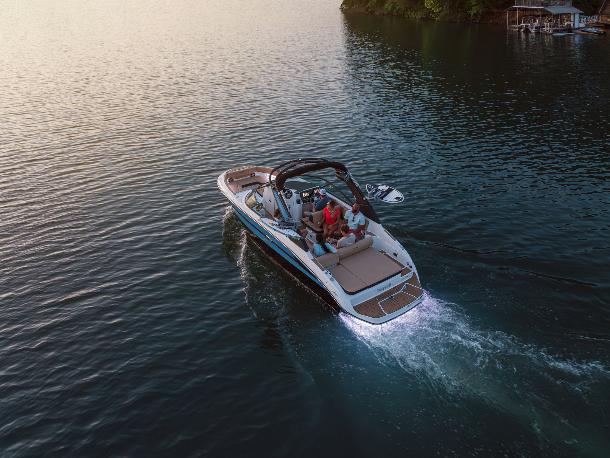 Aerial view of friends aboard an SDX 250 Surf at sunset