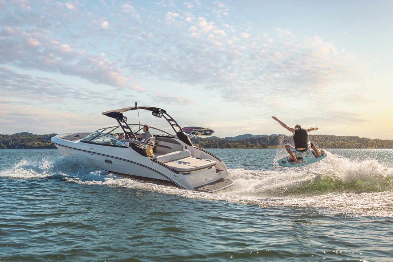 Man wakesurfing behind an SLX 260 Surf