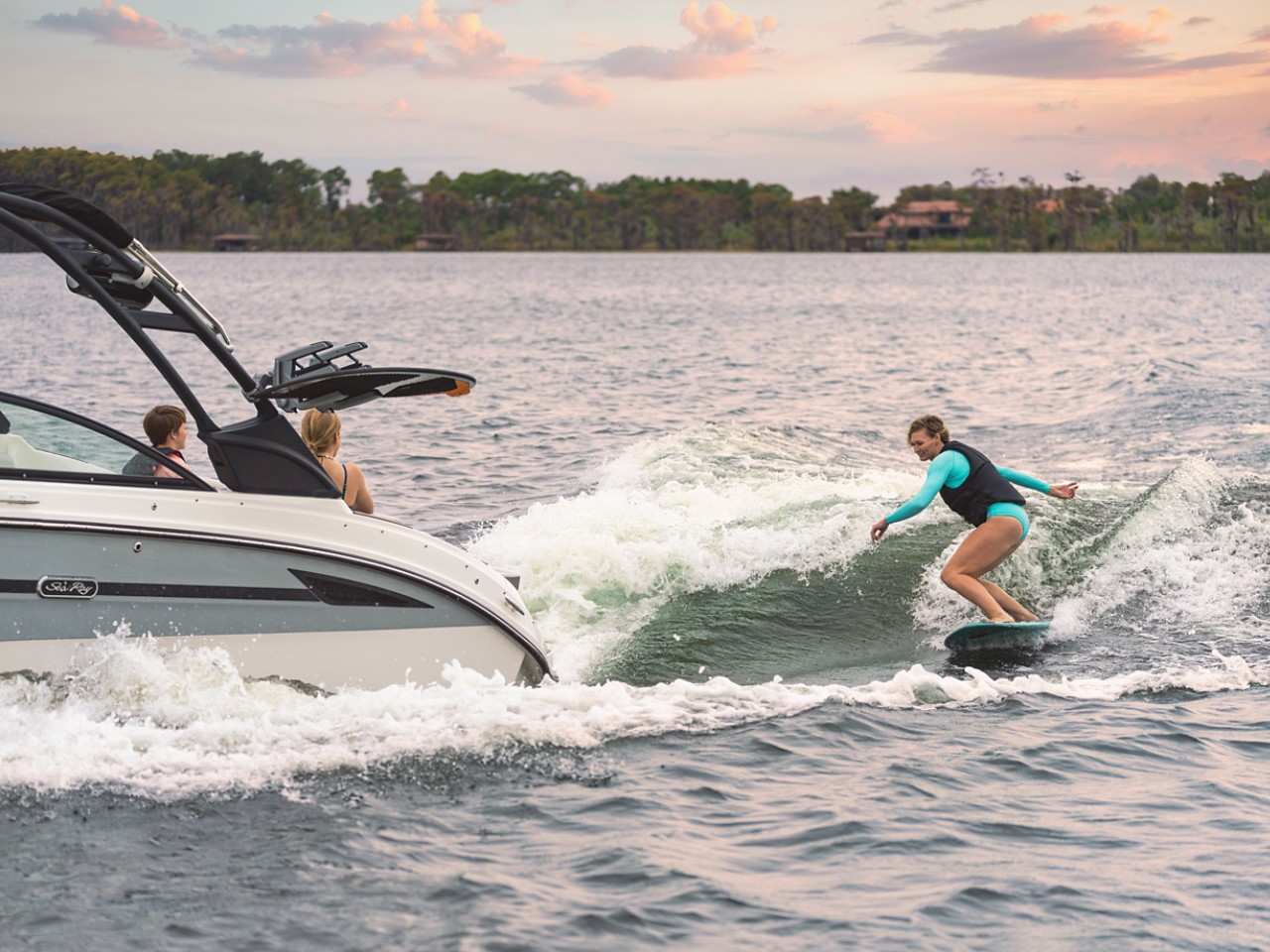 Woman wakesurfing behind a SDX 270 Surf